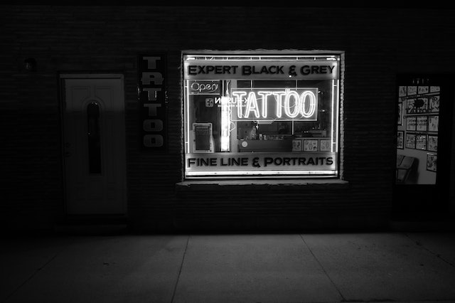 Grayscale Photo of Tattoo Neon Signage