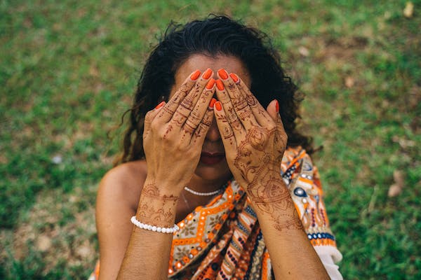 Indian woman hiding her eyes with her hands