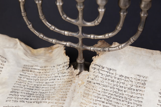 Menorah and parchment with a Torah scroll