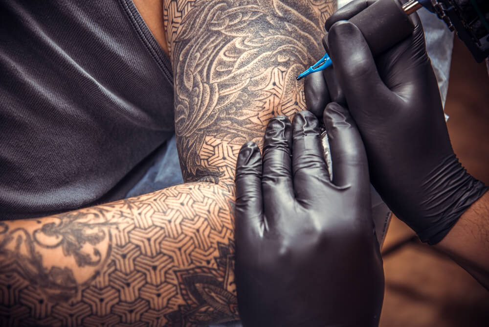 Tattooer makes cool tattoo in tattoo studio